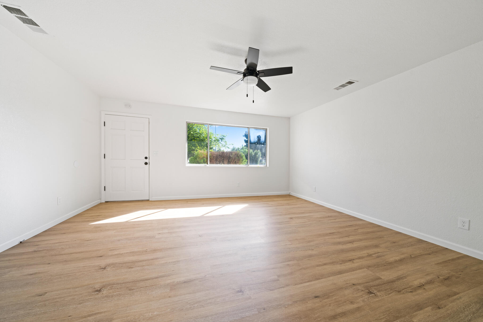 1430 Franzel Road Red Bluff, CA 96080 - Photo 3 of 27 wooden floor in an empty room with a window