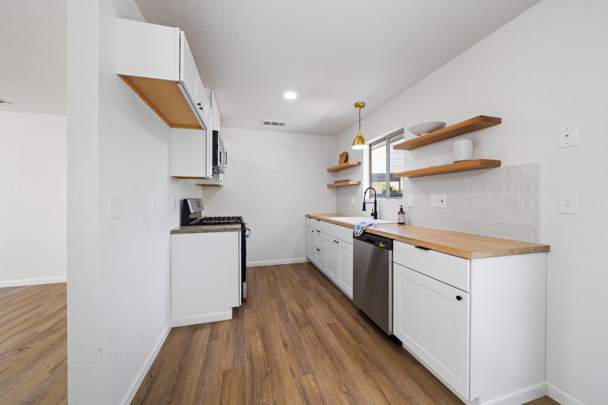 1430 Franzel Road Red Bluff, CA 96080 - Photo 6 of 27 a kitchen with sink cabinets and wooden floor