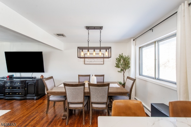 176 Harrison Road Parsippany, NJ 07054 - Photo 11 of 25 a view of a dining room with furniture window and wooden floor