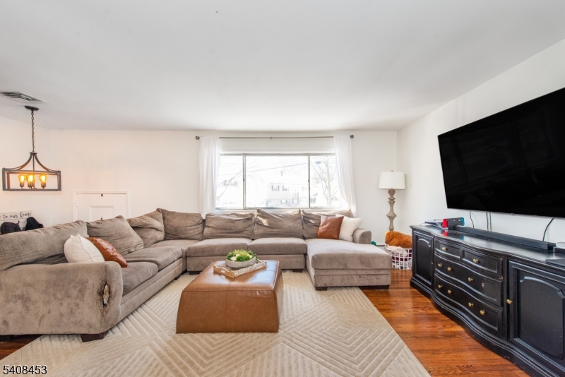 176 Harrison Road Parsippany, NJ 07054 - Photo 12 of 25 a living room with furniture and a flat screen tv