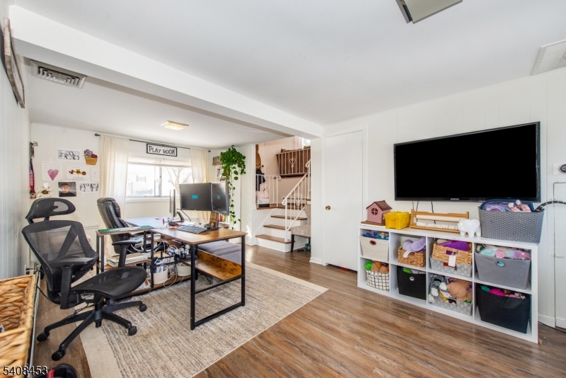 176 Harrison Road Parsippany, NJ 07054 - Photo 22 of 25 a living room with furniture and a flat screen tv