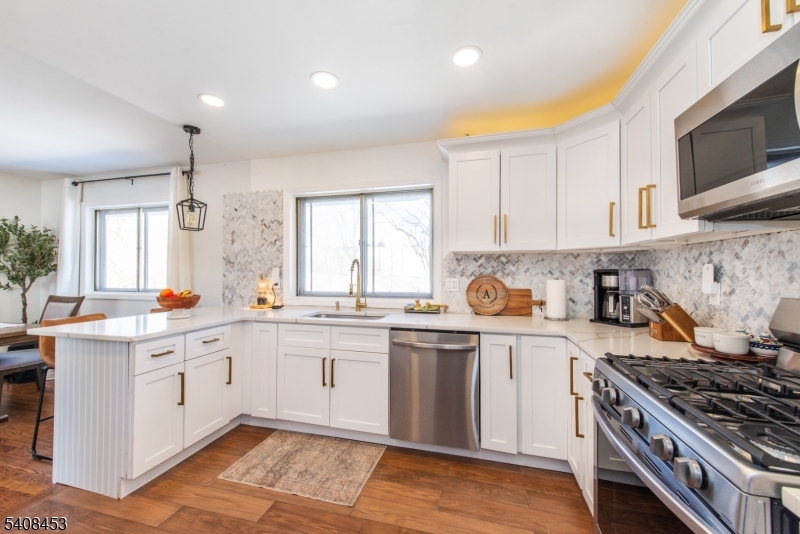176 Harrison Road Parsippany, NJ 07054 - Photo 3 of 25 a kitchen with stainless steel appliances granite countertop a stove and a sink