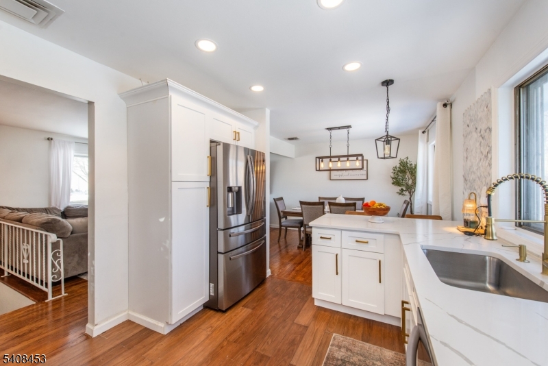 176 Harrison Road Parsippany, NJ 07054 - Photo 6 of 25 a kitchen with stainless steel appliances a refrigerator sink and cabinets