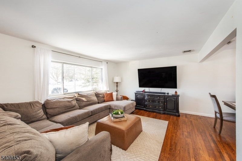 176 Harrison Road Parsippany, NJ 07054 - Photo 8 of 25 a living room with furniture and a flat screen tv
