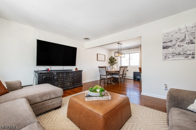 176 Harrison Road Parsippany, NJ 07054 - Photo 9 of 25 a living room with furniture and a flat screen tv