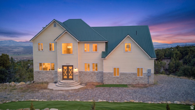 12645 East Cedar Ridge Drive Fairview, UT 84629 - Photo 1 of 34 Multi-story property featuring a prominent metal roof, light-toned siding, and stone accents
