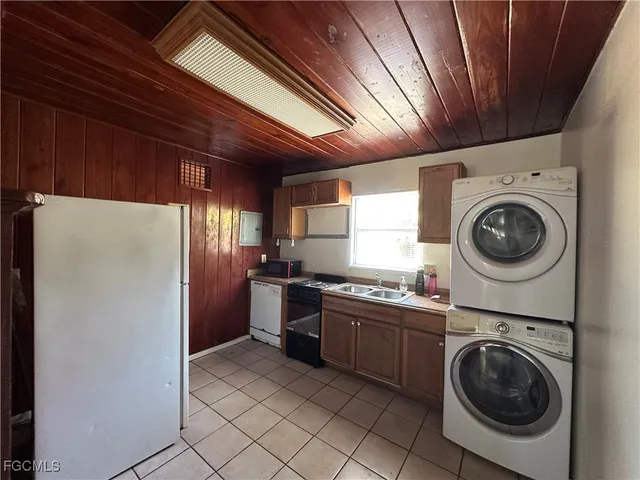 a utility room with sink dryer and washer