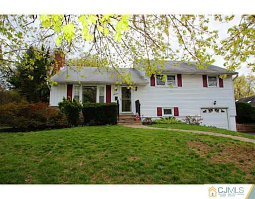 18 Dorian Road Metuchen, NJ 08840 - Photo 1 of 25 a front view of a house with a yard and trees