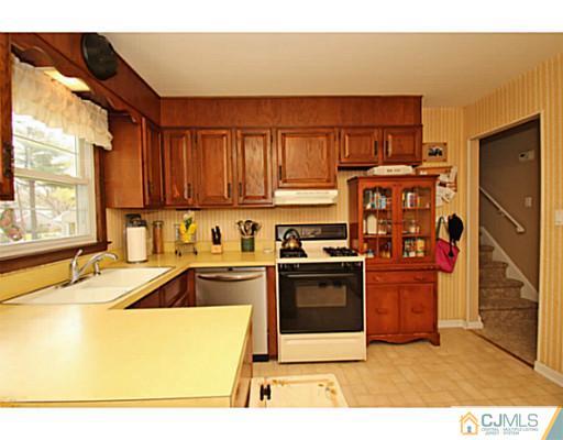 18 Dorian Road Metuchen, NJ 08840 - Photo 13 of 25 a kitchen with stainless steel appliances granite countertop a sink stove and refrigerator