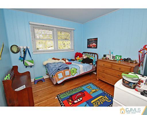 18 Dorian Road Metuchen, NJ 08840 - Photo 20 of 25 a bedroom with furniture and a window