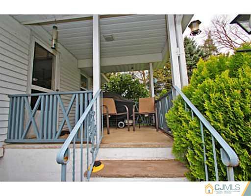 18 Dorian Road Metuchen, NJ 08840 - Photo 22 of 25 a view of a porch with chairs and potted plants