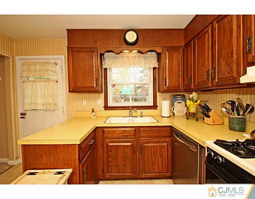 18 Dorian Road Metuchen, NJ 08840 - Photo 4 of 25 a kitchen with a sink and a stove