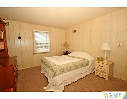 18 Dorian Road Metuchen, NJ 08840 - Photo 7 of 25 a bedroom with a bed and a night stand
