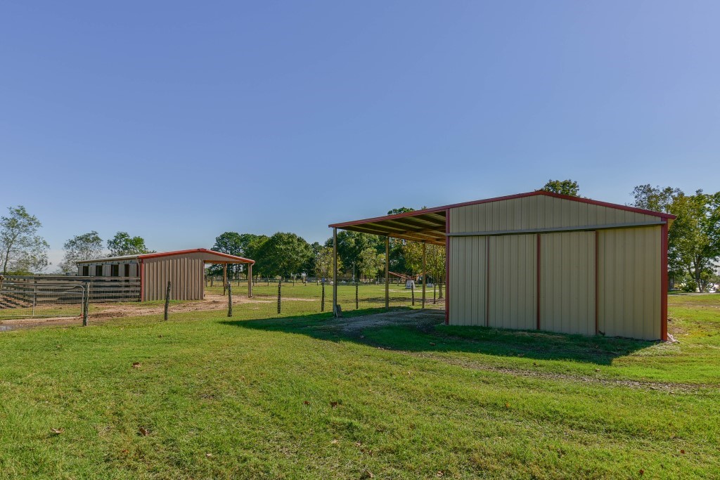 34366 Owens Road Hempstead, TX 77445 - Photo 23 of 46 Detached storage building provides convenient space for tools, lawn equipment, feed, tack, or additional storage while overlooking the surrounding pasture.
