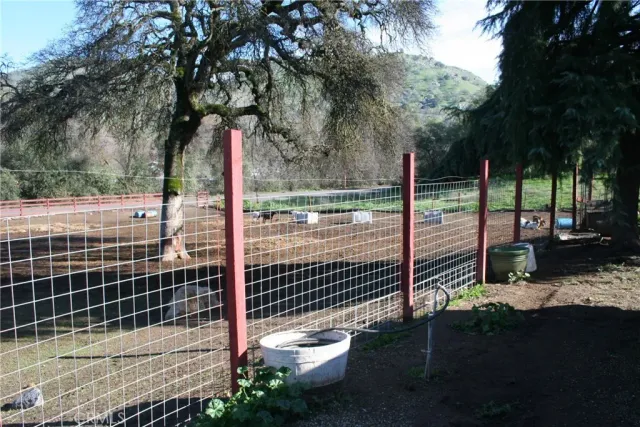 a view of a park with iron fence