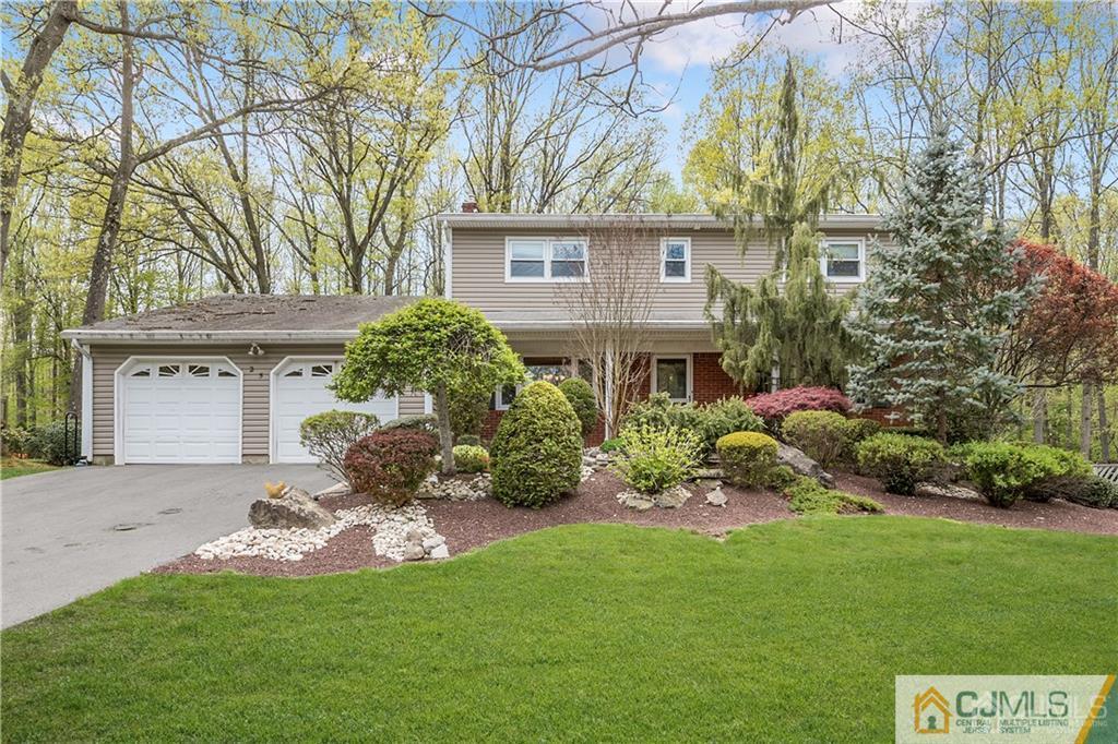 25 Timber Road East Brunswick, NJ 08816 - Photo 1 of 22 a front view of a house with a garden and plants