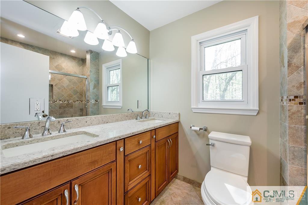 25 Timber Road East Brunswick, NJ 08816 - Photo 12 of 22 a bathroom with a toilet sink and mirror