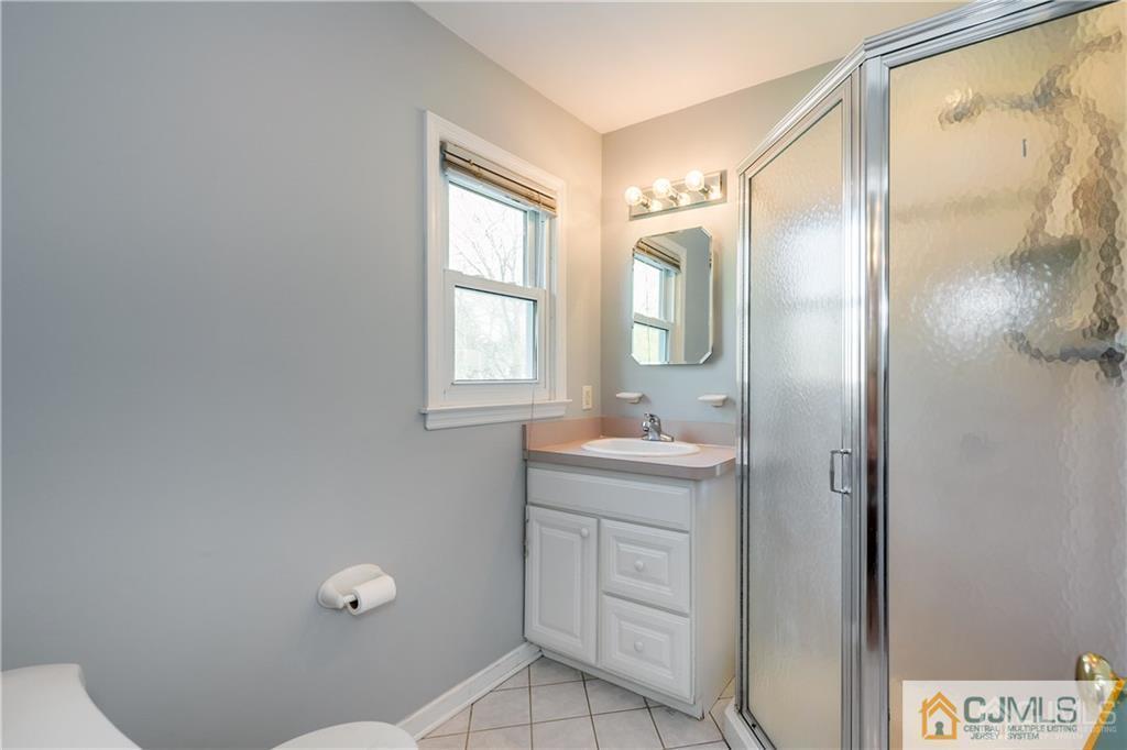 25 Timber Road East Brunswick, NJ 08816 - Photo 13 of 22 a bathroom with a granite countertop sink a mirror and a shower