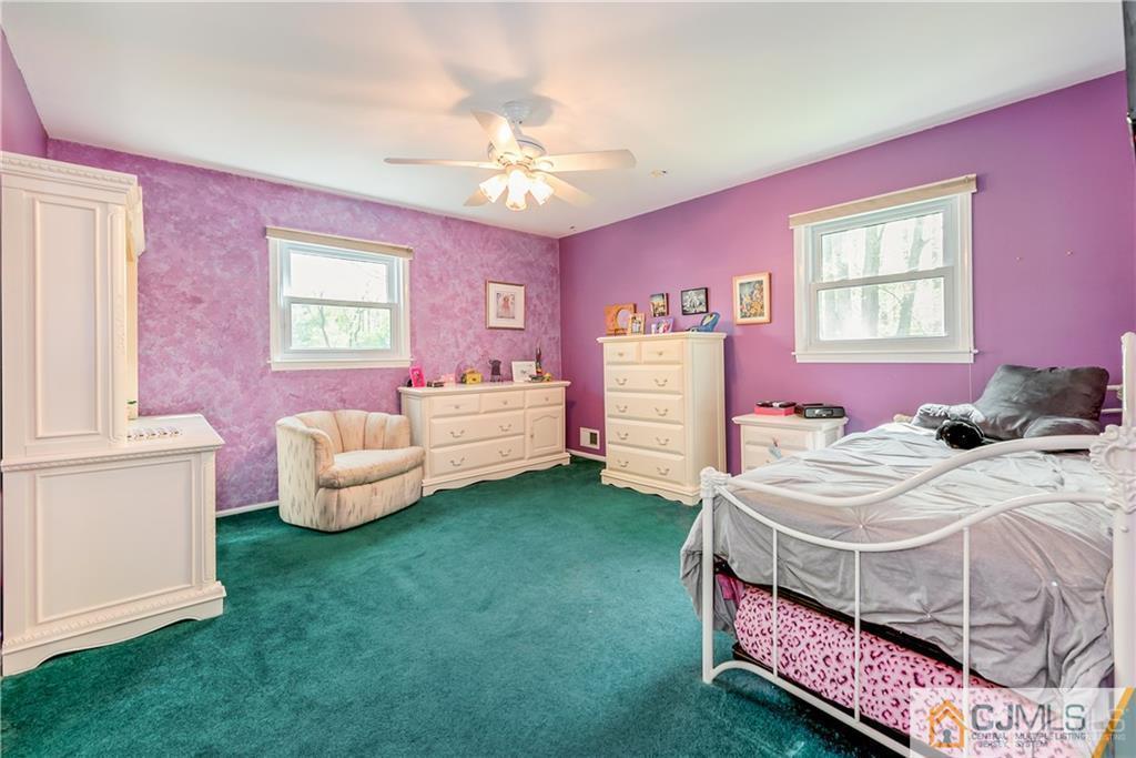 25 Timber Road East Brunswick, NJ 08816 - Photo 16 of 22 a bedroom with a bed and a chandelier