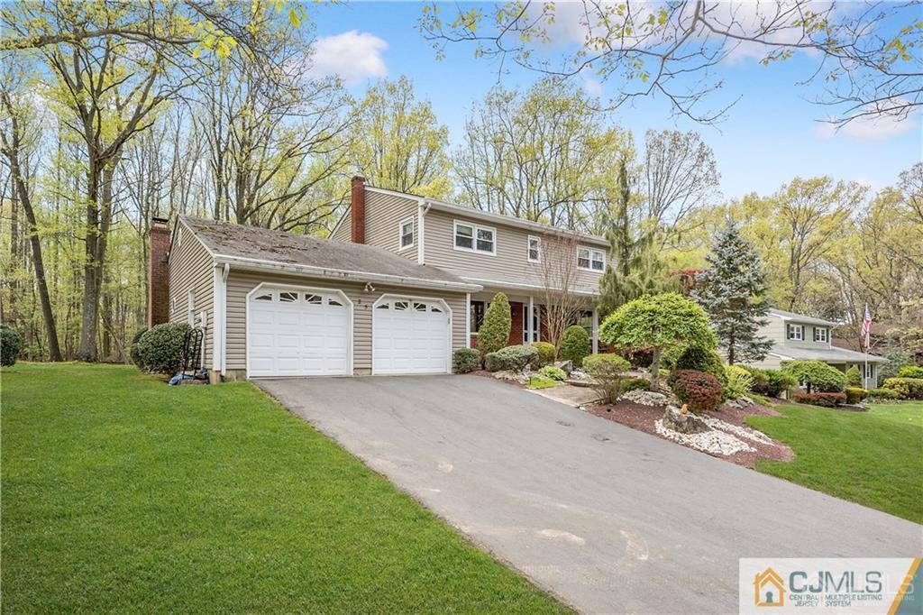 25 Timber Road East Brunswick, NJ 08816 - Photo 2 of 22 a front view of a house with a yard and garage