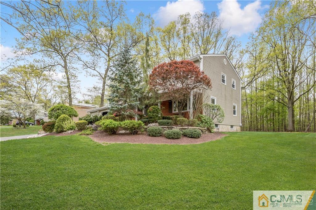 25 Timber Road East Brunswick, NJ 08816 - Photo 3 of 22 a front view of a house with garden and trees