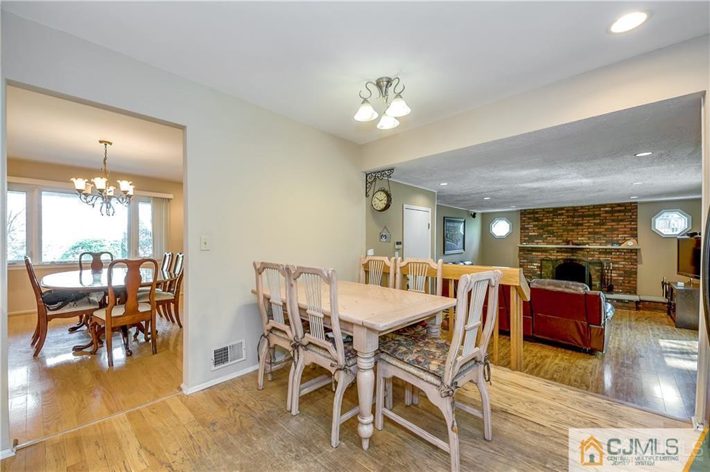 25 Timber Road East Brunswick, NJ 08816 - Photo 7 of 22 a view of a dining room with furniture window and wooden floor