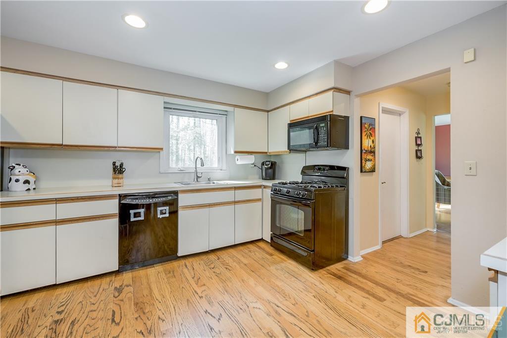 25 Timber Road East Brunswick, NJ 08816 - Photo 9 of 22 a kitchen with granite countertop a refrigerator stove top oven and sink