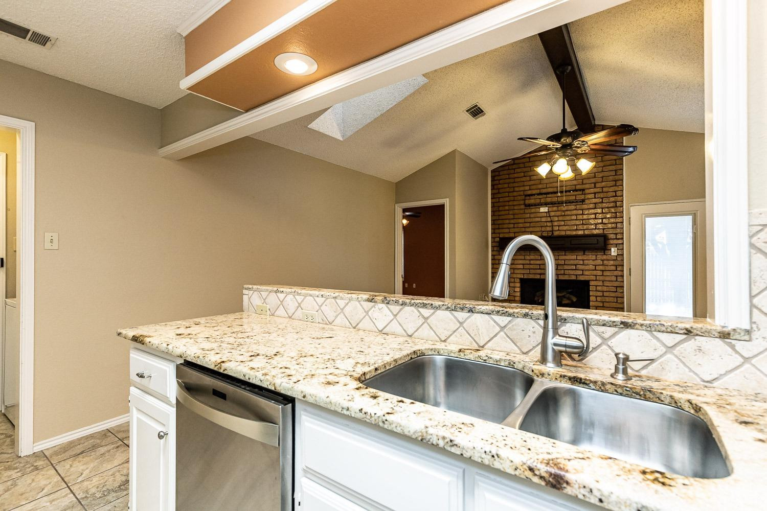 3202 66th Street, Unit A Lubbock, TX 79413 - Photo 12 of 37 Kitchen With Granite Countertops
