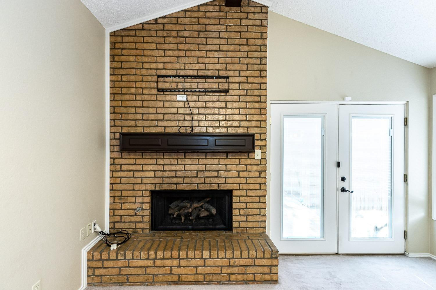 3202 66th Street, Unit A Lubbock, TX 79413 - Photo 6 of 37 Fireplace with Gas Logs