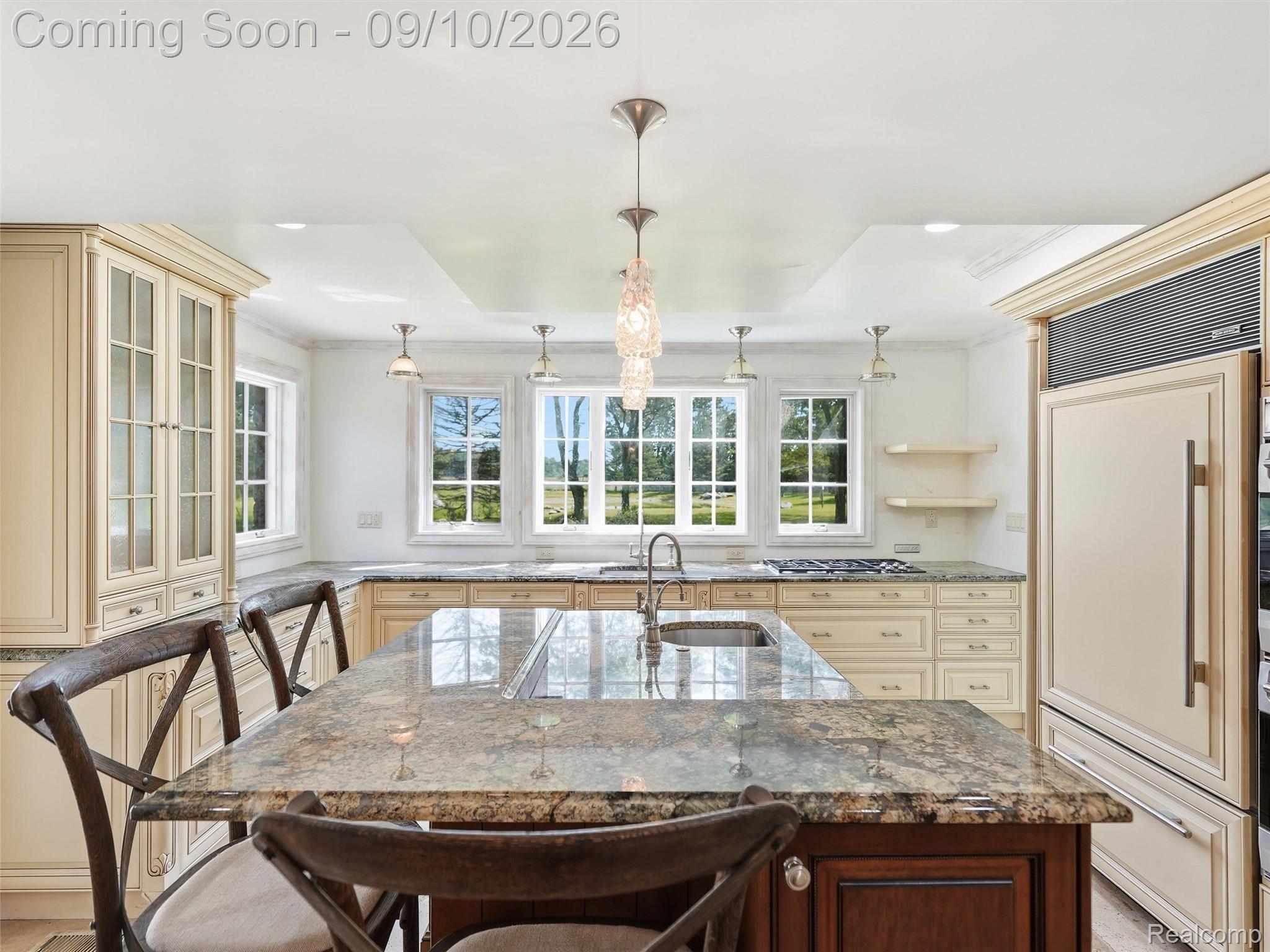 61400 Romeo Plank Road Ray, MI 48096 - Photo 41 of 99 Kitchen featuring a central island with a stone countertop, built-in sink, and pendant lighting