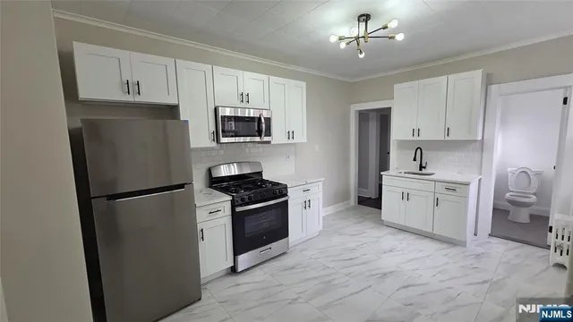 a kitchen with a refrigerator stove and sink