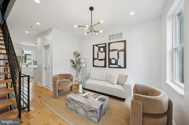 a living room with furniture a rug and a window