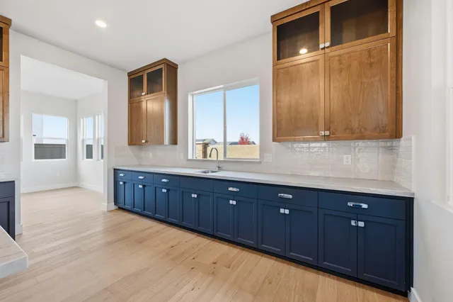 a spacious bathroom with a granite countertop sink and mirror