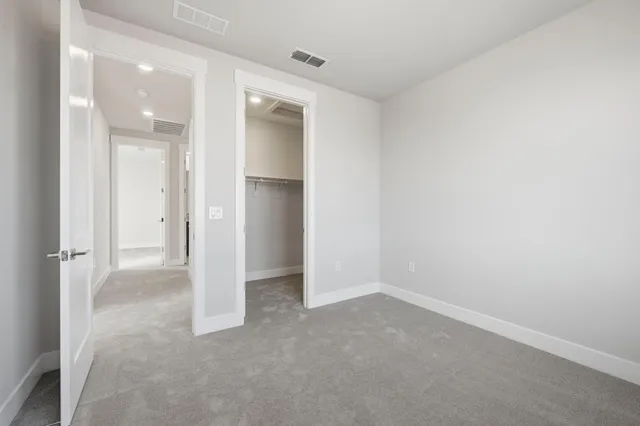 a view of an empty room and closet area