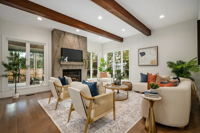 a kitchen with a dining table chairs and white cabinets