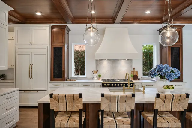 a kitchen with stainless steel appliances granite countertop a stove a sink and a refrigerator