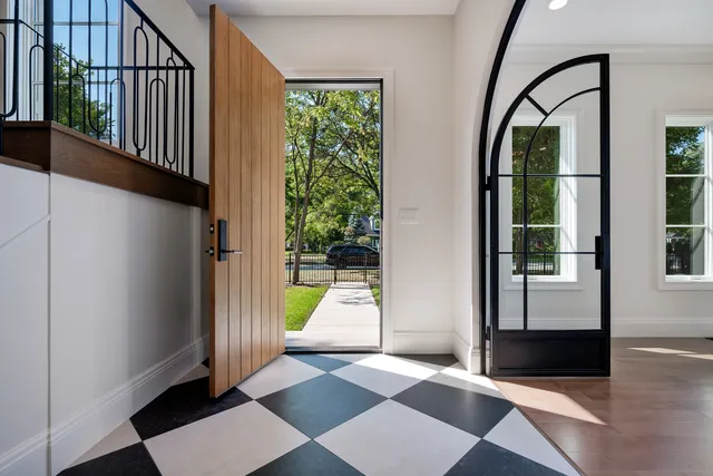 a view of a dining room with furniture a potted plant and wooden floor