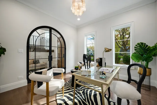 a living room with furniture a window and a chandelier
