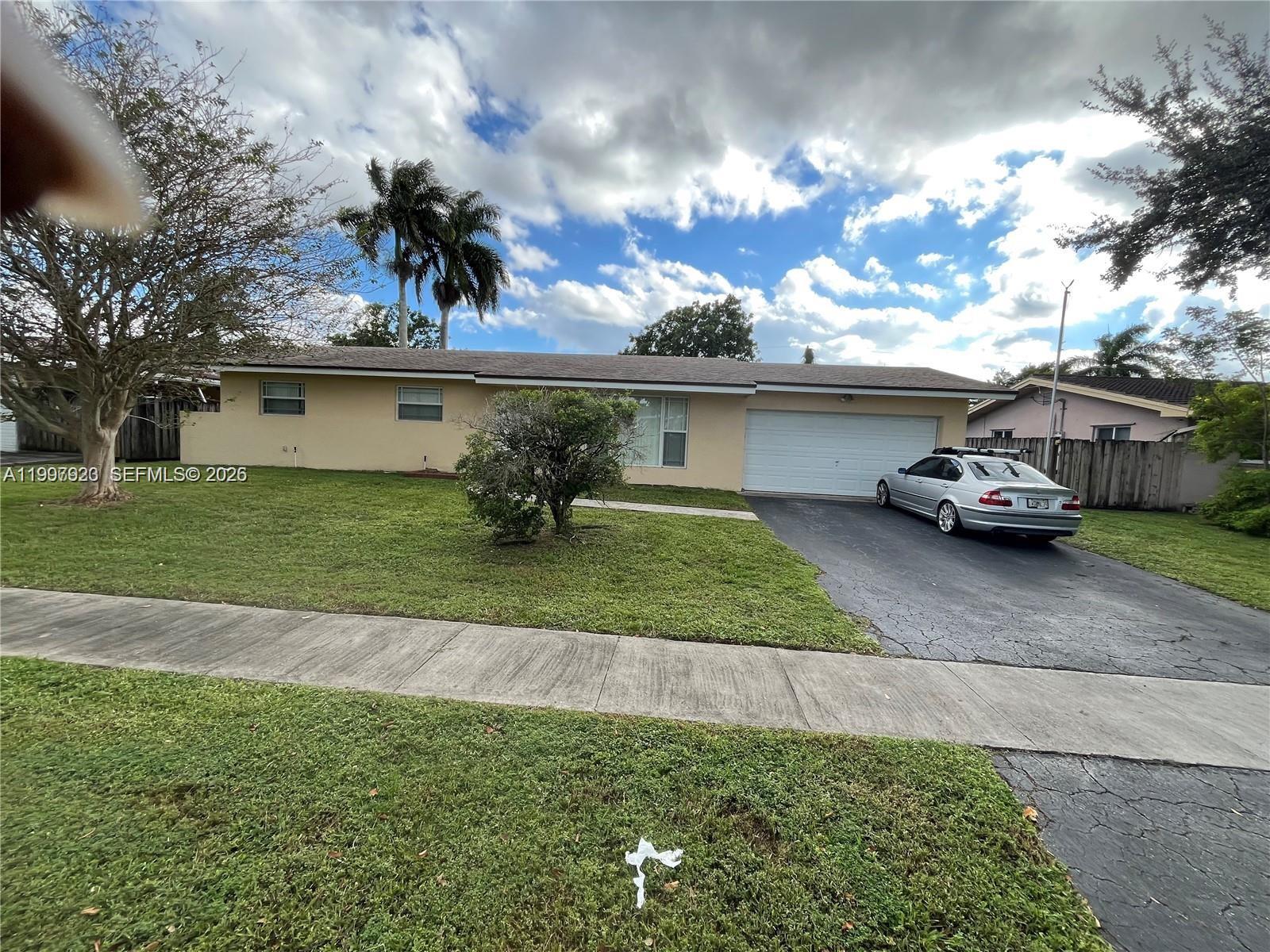 7200 Northwest 10th Place Plantation, FL 33313 - Photo 1 of 2 a car parked in front of a house