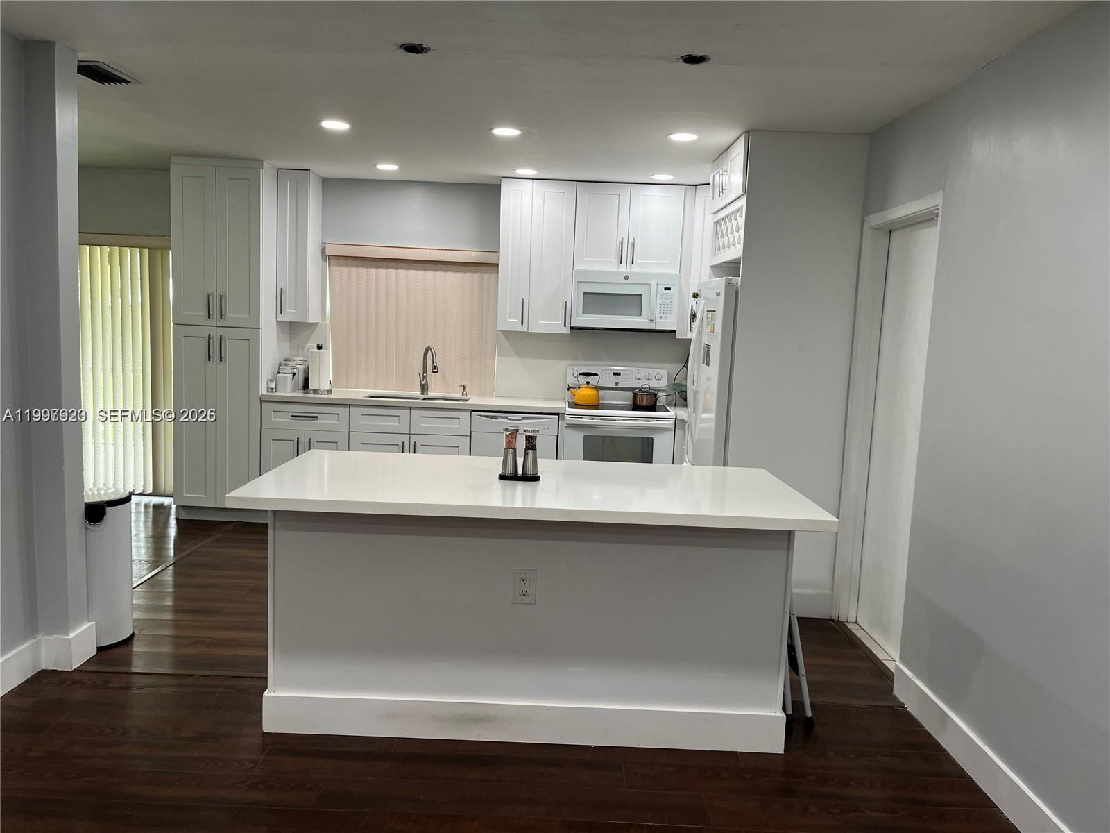 7200 Northwest 10th Place Plantation, FL 33313 - Photo 2 of 2 a kitchen with kitchen island stainless steel appliances a sink and refrigerator