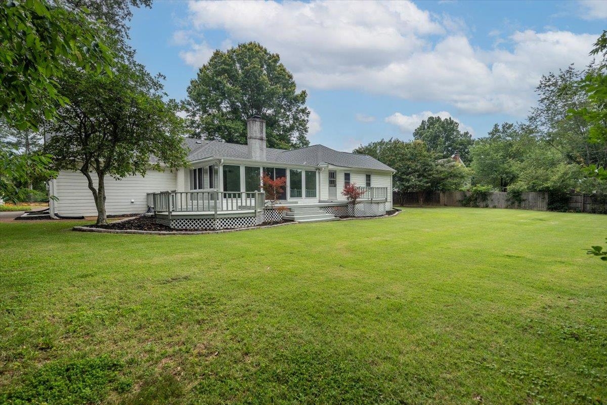 670 Peterson Lake Road Collierville, TN 38017 - Photo 30 of 37 Expansive rear yard featuring a large green lawn, mature trees, and a multi-level wooden deck