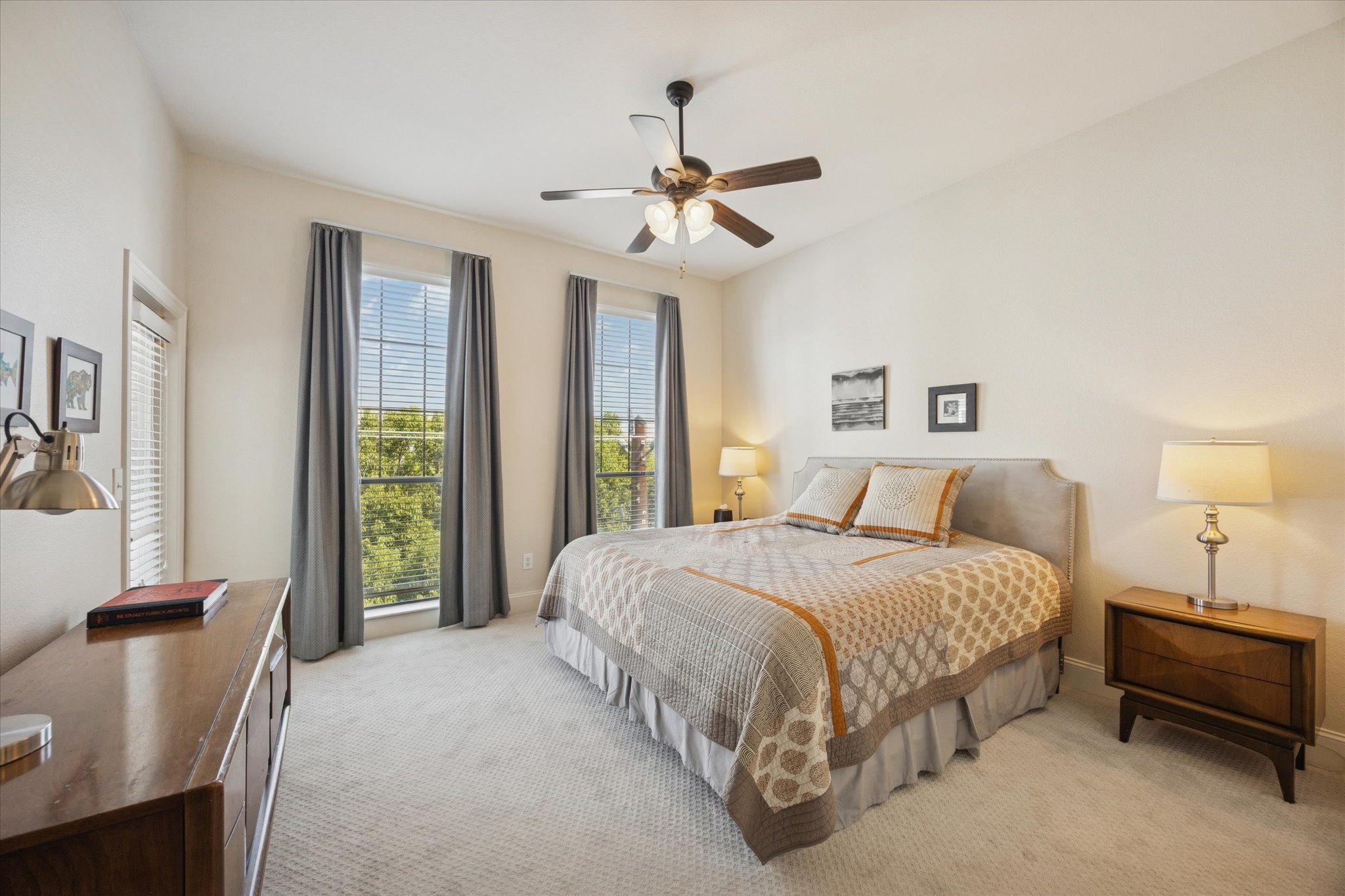 2120 Kipling Street, Unit 406 Houston, TX 77098 - Photo 12 of 19 a bedroom with a balcony a bed and a chandelier