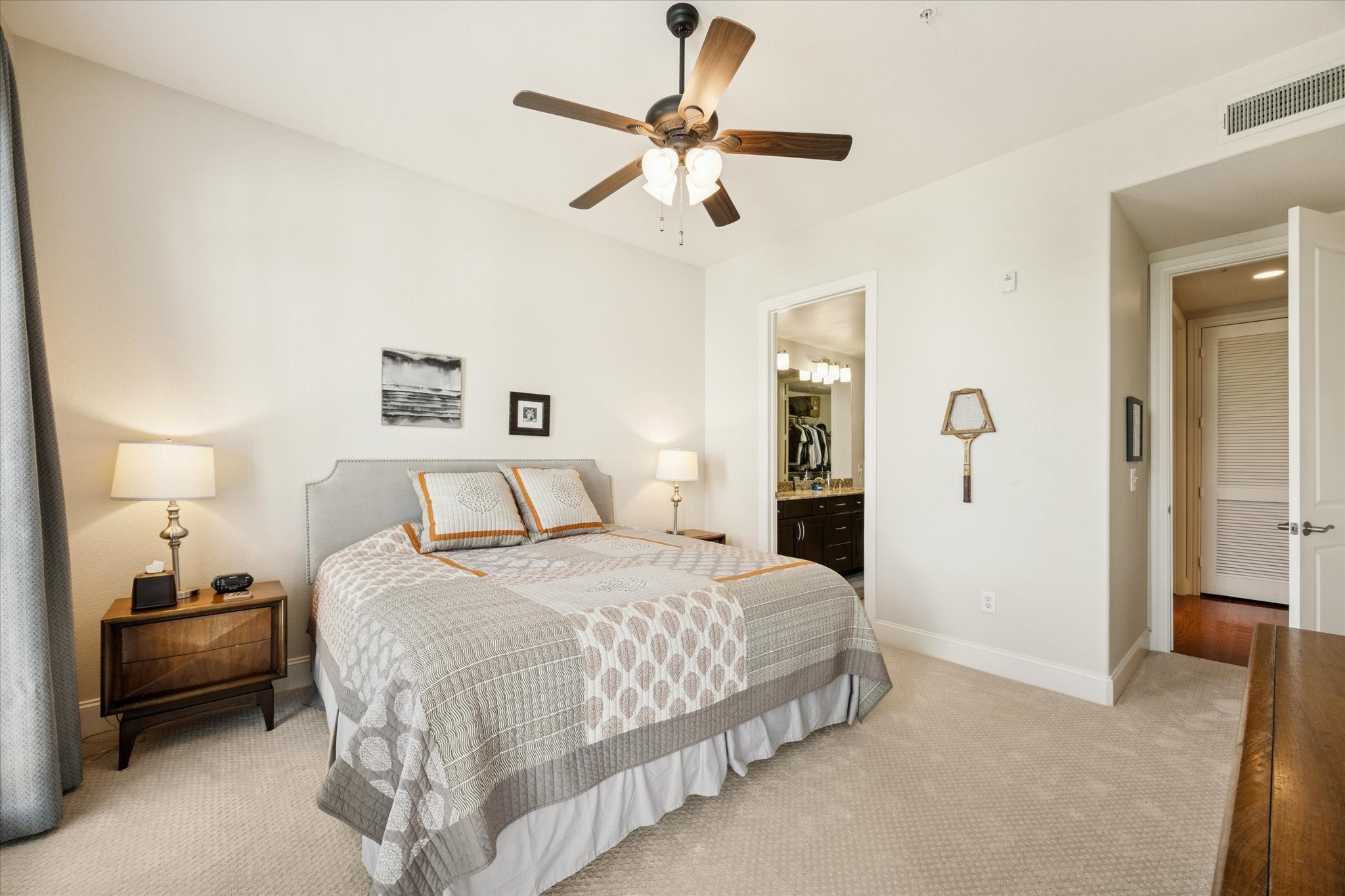 2120 Kipling Street, Unit 406 Houston, TX 77098 - Photo 13 of 19 a bedroom with a bed and a chandelier