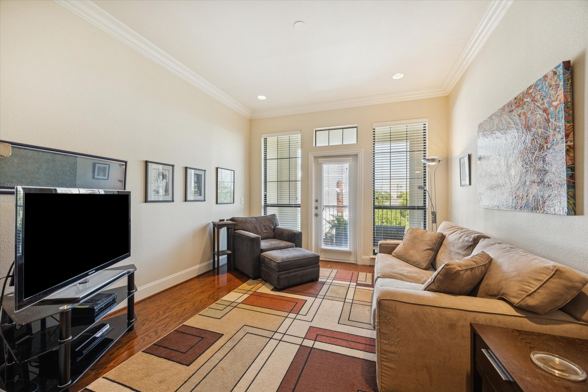 2120 Kipling Street, Unit 406 Houston, TX 77098 - Photo 5 of 19 a living room with furniture and a flat screen tv