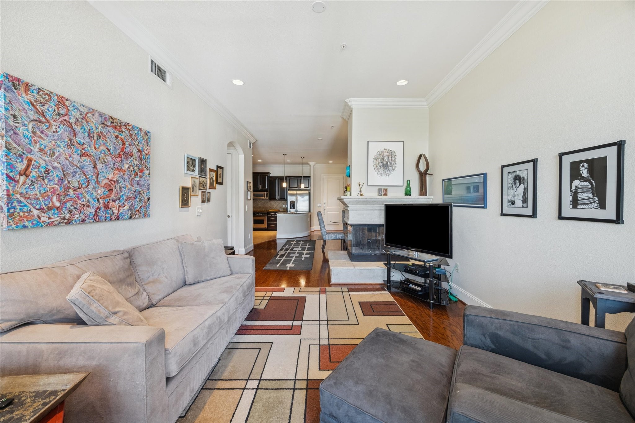 2120 Kipling Street, Unit 406 Houston, TX 77098 - Photo 7 of 19 a living room with furniture and a flat screen tv