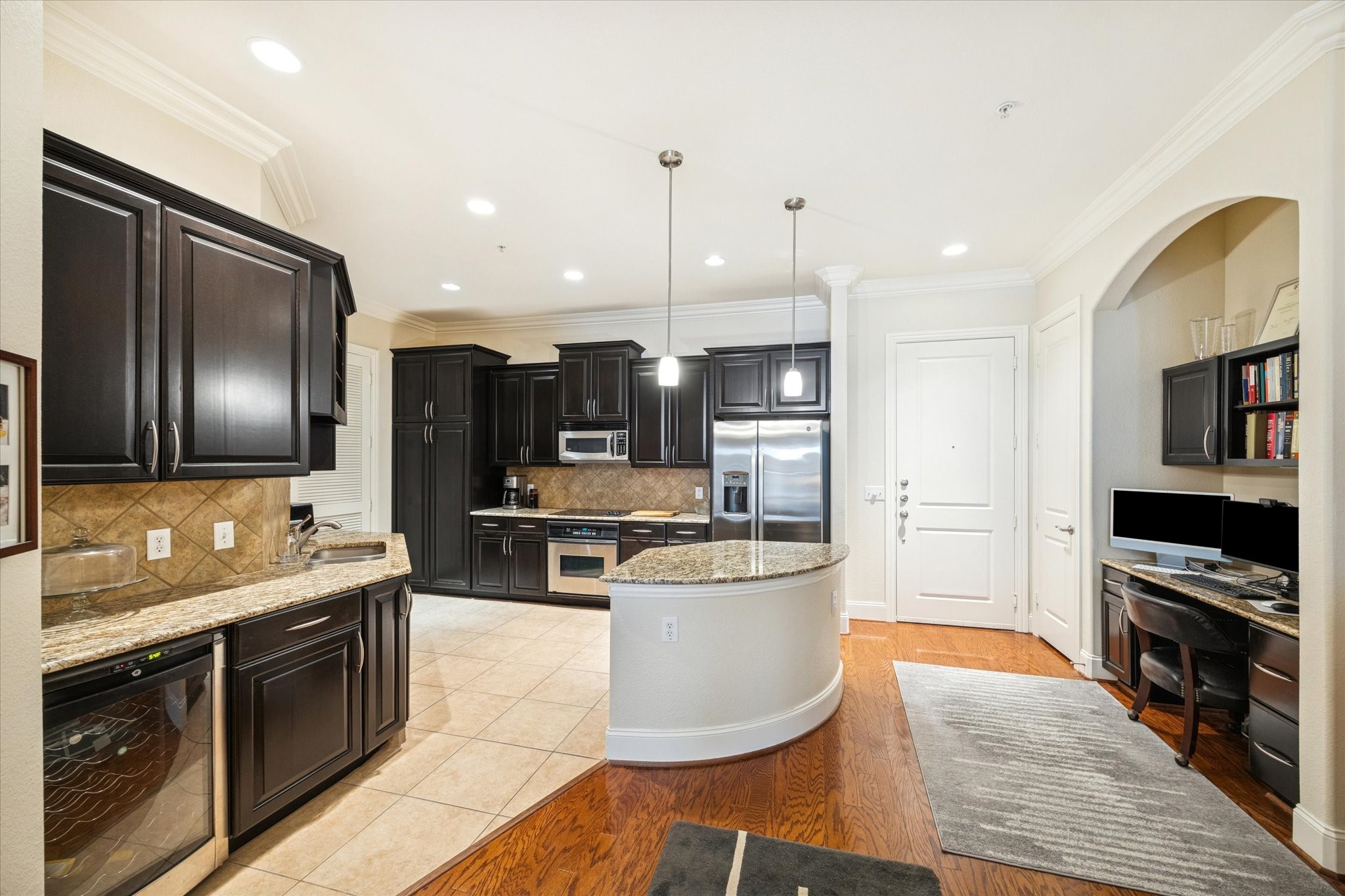 2120 Kipling Street, Unit 406 Houston, TX 77098 - Photo 19 of 19 a large kitchen with stainless steel appliances kitchen island granite countertop a stove a sink dishwasher and a refrigerator with wooden floor