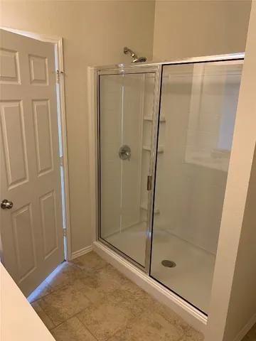 a bathroom with a glass shower door