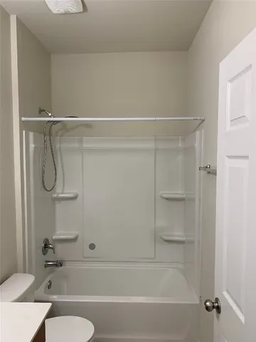 a bathroom with a shower and a toilet