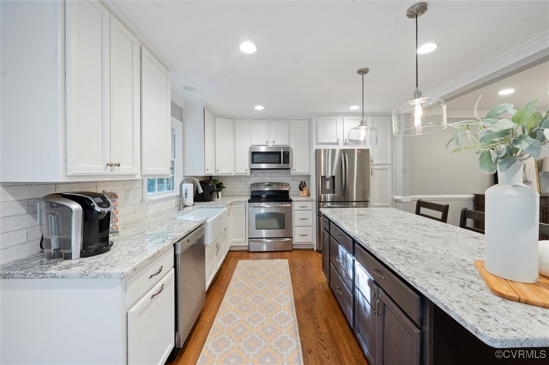 4107 Poplar Grove Road Midlothian, VA 23112 - Photo 25 of 38 a kitchen with granite countertop kitchen island stainless steel appliances a sink dishwasher a refrigerator a stove top oven a counter space and cabinets