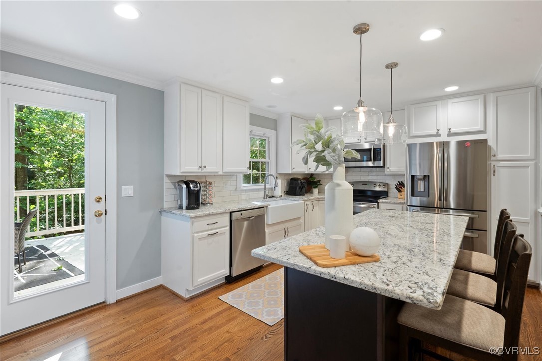 4107 Poplar Grove Road Midlothian, VA 23112 - Photo 4 of 38 a kitchen with stainless steel appliances granite countertop a refrigerator a sink dishwasher a stove and white cabinets with wooden floor